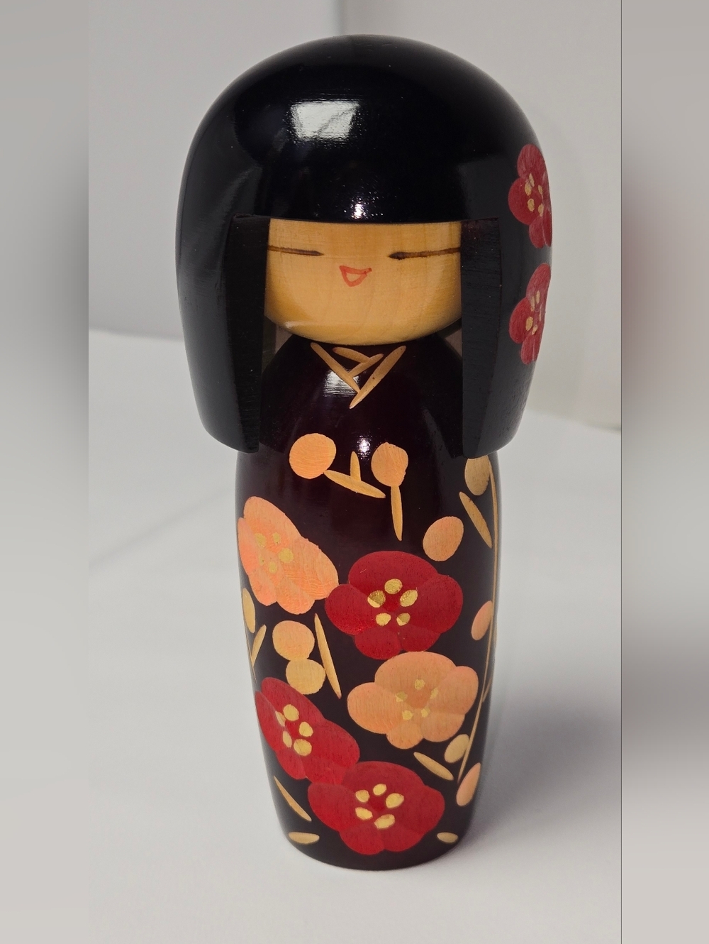 Wooden Kokeshi Doll with Red and Peach Floral Motif